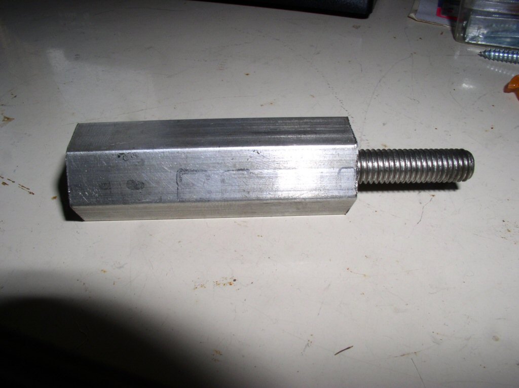 Charlie Mullendore of Antietam Classic Cycle sent me this photo of the adapter he made for his puller. In Charlie's own words: I didn't have any steel hex (or round) on hand so just used 3&frasl;4 inch aluminum hex and it worked just fine. One end is drilled and tapped 9&frasl;16 inch-12, the other 8 mm - 1.25 mm. The 9&frasl;16 inch end I screwed onto the OTC blind bearing puller shaft on the handle end (the handle isn't pinned into place, the other end is) and I cut the head off an 8 mm bolt for the output shaft end. Worked perfectly.